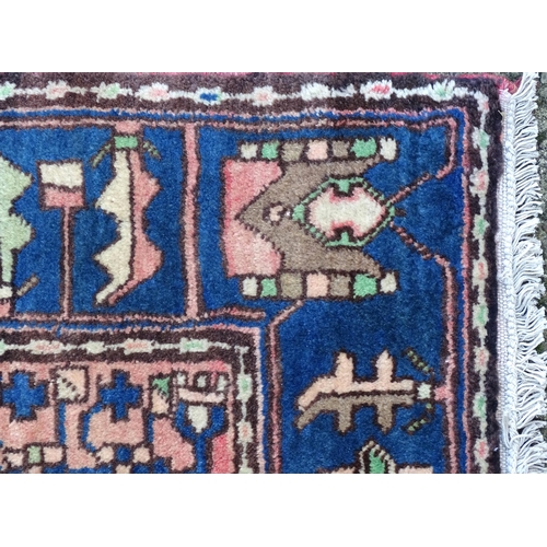 1376 - Carpet / Rug : A Nahawand rug, stylised floral motifs and geometric symbols on a ground of blue, cre... 