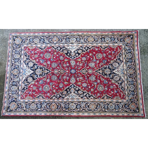 1378 - Carpet / Rug : A Kashan rug, the red, blue and cream grounds with stylised floral motifs.  Approx. 8... 