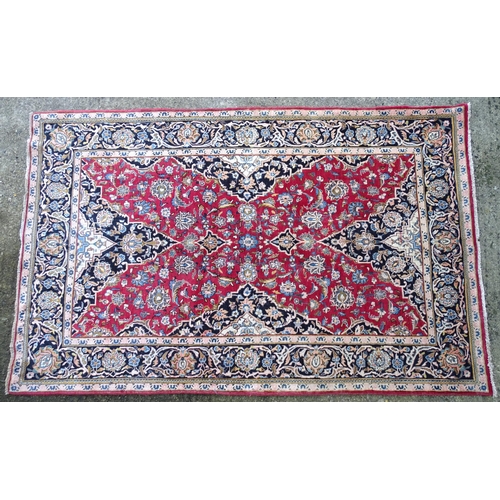 1378 - Carpet / Rug : A Kashan rug, the red, blue and cream grounds with stylised floral motifs.  Approx. 8... 