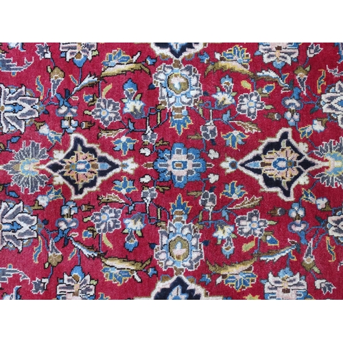 1378 - Carpet / Rug : A Kashan rug, the red, blue and cream grounds with stylised floral motifs.  Approx. 8... 