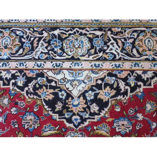 1378 - Carpet / Rug : A Kashan rug, the red, blue and cream grounds with stylised floral motifs.  Approx. 8... 