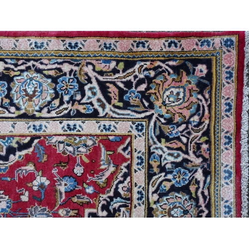 1378 - Carpet / Rug : A Kashan rug, the red, blue and cream grounds with stylised floral motifs.  Approx. 8... 