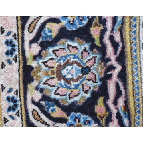 1378 - Carpet / Rug : A Kashan rug, the red, blue and cream grounds with stylised floral motifs.  Approx. 8... 