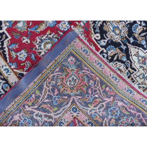 1378 - Carpet / Rug : A Kashan rug, the red, blue and cream grounds with stylised floral motifs.  Approx. 8... 