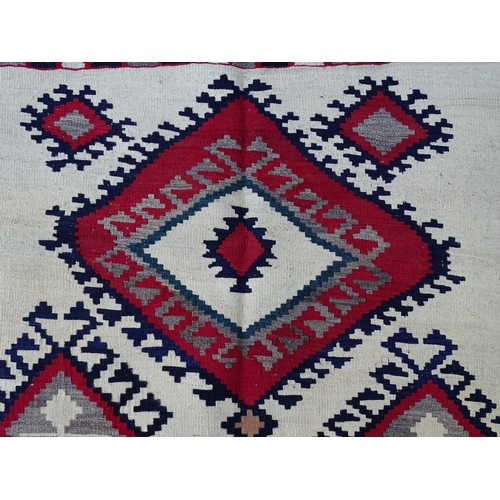 1380 - Carpet / Rug : A Qashqai kilim, the cream ground with red, blue and grey geometric decoration. Appro... 