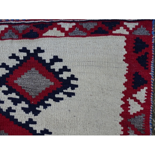 1380 - Carpet / Rug : A Qashqai kilim, the cream ground with red, blue and grey geometric decoration. Appro... 