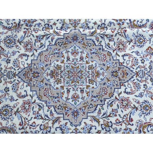 1382 - Carpet / Rug : A Kashan carpet, the cream and beige ground with central medallion and floral and fol... 