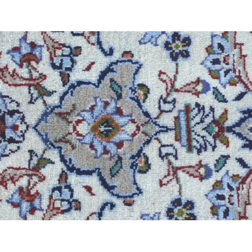 1382 - Carpet / Rug : A Kashan carpet, the cream and beige ground with central medallion and floral and fol... 