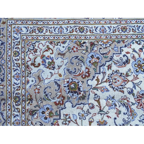 1382 - Carpet / Rug : A Kashan carpet, the cream and beige ground with central medallion and floral and fol... 