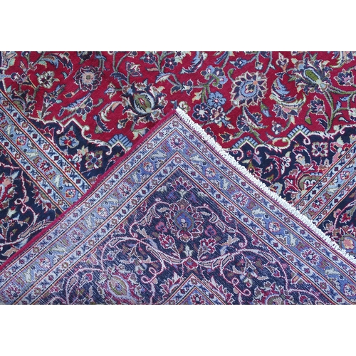 1384 - Carpet / Rug : A Kashan carpet, the red, blue and cream ground with central medallion and floral and... 