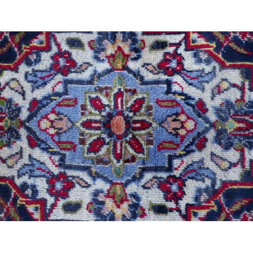 1384 - Carpet / Rug : A Kashan carpet, the red, blue and cream ground with central medallion and floral and... 