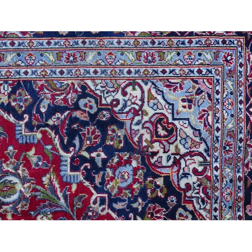 1384 - Carpet / Rug : A Kashan carpet, the red, blue and cream ground with central medallion and floral and... 