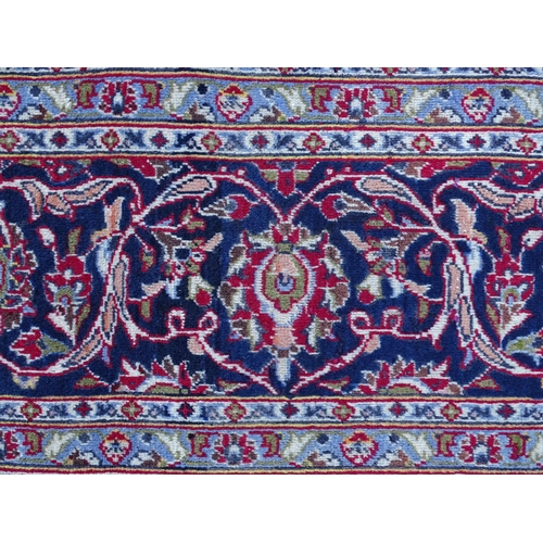 1384 - Carpet / Rug : A Kashan carpet, the red, blue and cream ground with central medallion and floral and... 