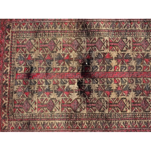 1388 - Carpet / Rug : A rug with red / pink ground and banded geometric decoration  Approx. 54