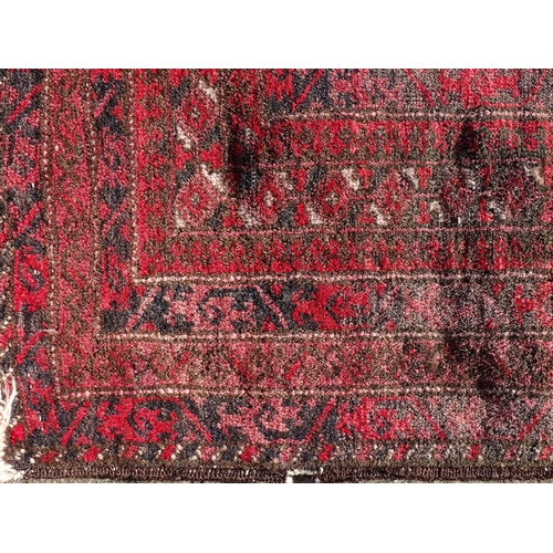 1388 - Carpet / Rug : A rug with red / pink ground and banded geometric decoration  Approx. 54