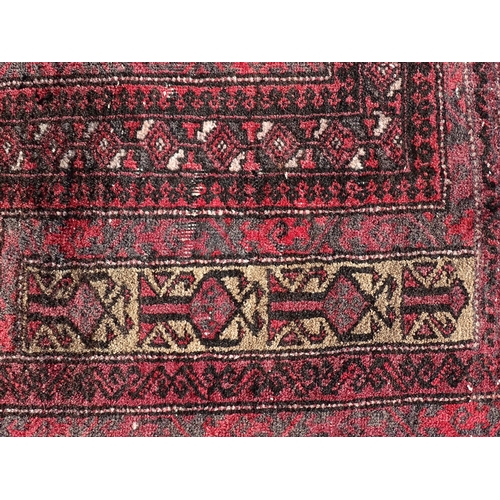 1388 - Carpet / Rug : A rug with red / pink ground and banded geometric decoration  Approx. 54