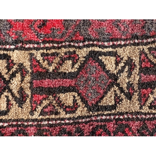 1388 - Carpet / Rug : A rug with red / pink ground and banded geometric decoration  Approx. 54