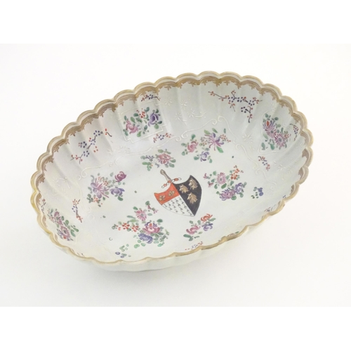 2 - A Chinese export bowl of oval form with scalloped edge, decorated with flowers, foliage and armorial... 