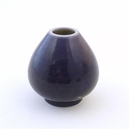 23 - A small Chinese pot of teardrop form with an indigo glaze. Character marks under. Approx. 2