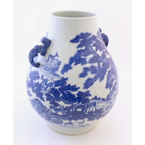 28 - A large Chinese Hu vase with scrolled twin handles, the body decorated in blue and white with the Hu... 