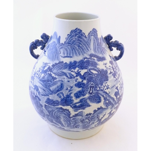 28 - A large Chinese Hu vase with scrolled twin handles, the body decorated in blue and white with the Hu... 