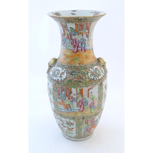 30 - A Chinese famile rose vase with a flared rim and twin ring mask handles in relief, decorated with fi... 