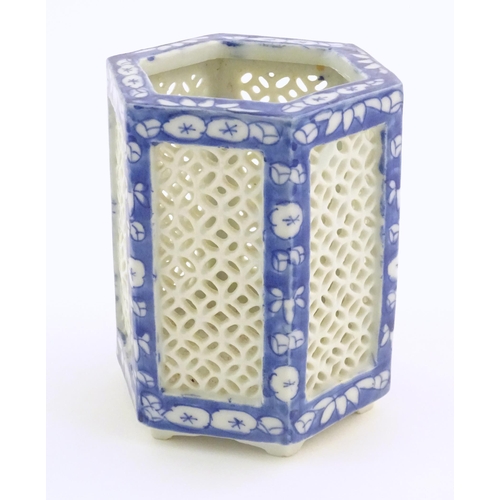 4 - An Oriental hexagonal pot pourri holder with blue and white floral detail and reticulated panels. Ap... 