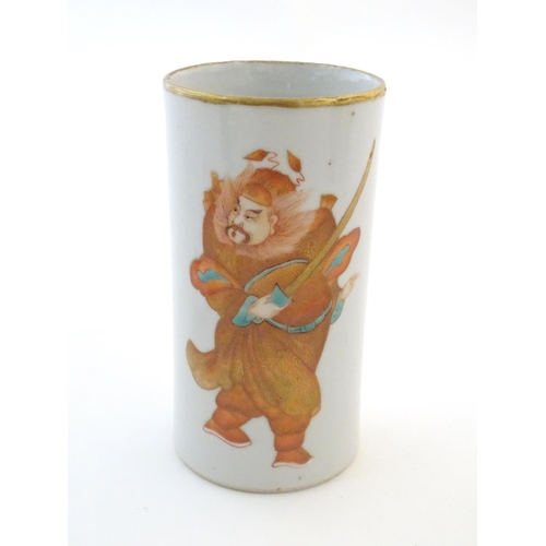 7 - A Chinese brush pot of cylindrical form depicting a figure with a sword and stylised bats, with gilt... 