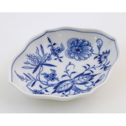 73 - A Continental dish of lozenge form with blue and white decoration depicting flowers and foliage. Wit... 