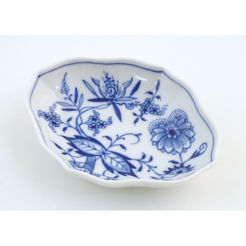 73 - A Continental dish of lozenge form with blue and white decoration depicting flowers and foliage. Wit... 