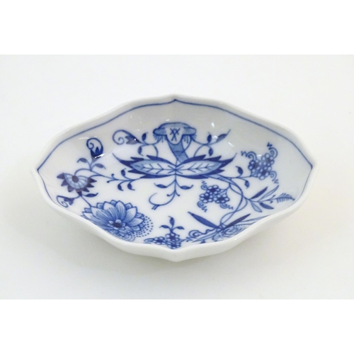 73 - A Continental dish of lozenge form with blue and white decoration depicting flowers and foliage. Wit... 