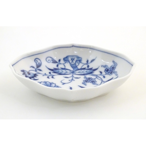 73 - A Continental dish of lozenge form with blue and white decoration depicting flowers and foliage. Wit... 