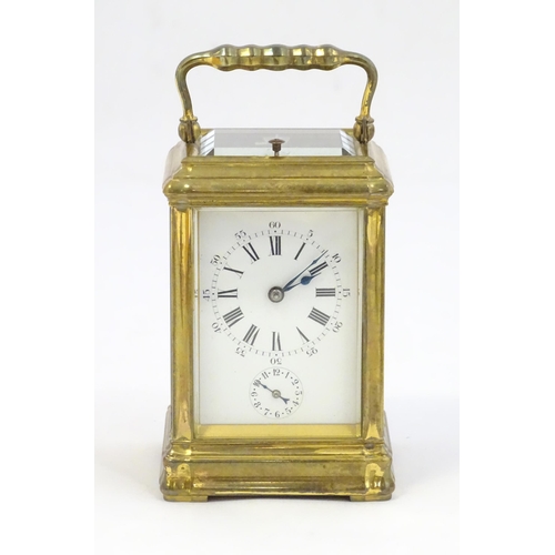 Le Roy & Fils - A 19thC French quarter repeat brass cased carriage clock, having enamel dial with Roman numerals and subsidiary dial with Arabic numerals, striking on a gong.  The movement numbered 11198 and with patent under winding marked Le Roy & Fils Patent no. 9501. Standing 5 3/4" high overall 

With receipt from Charles Frodsham & Co Ltd. dated 1959 and Insurance valuation from L Fairbairn of Putney dated 1977.