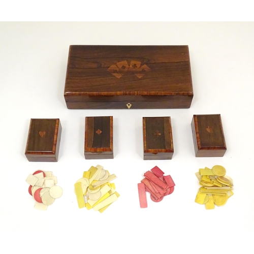 1302 - A 19thC rosewood games box, the lid decorated with playing card suits opening two reveal a fitted in... 