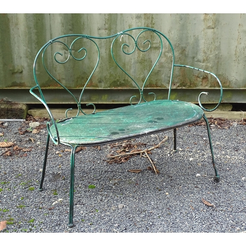 1364 - A two-seater garden bench, of wrought metal construction with two hearts forming the splat, green pa... 