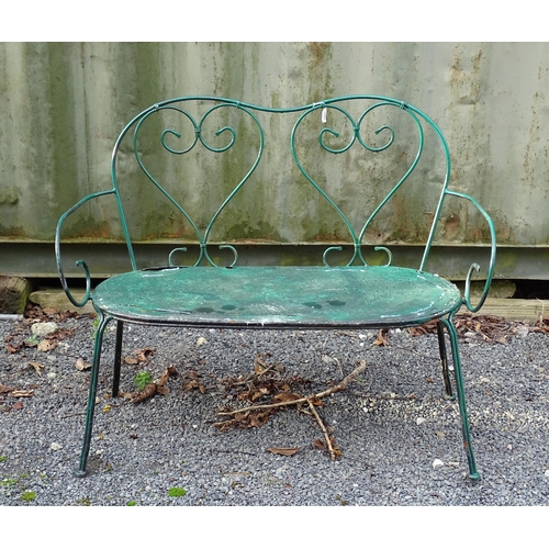 1364 - A two-seater garden bench, of wrought metal construction with two hearts forming the splat, green pa... 