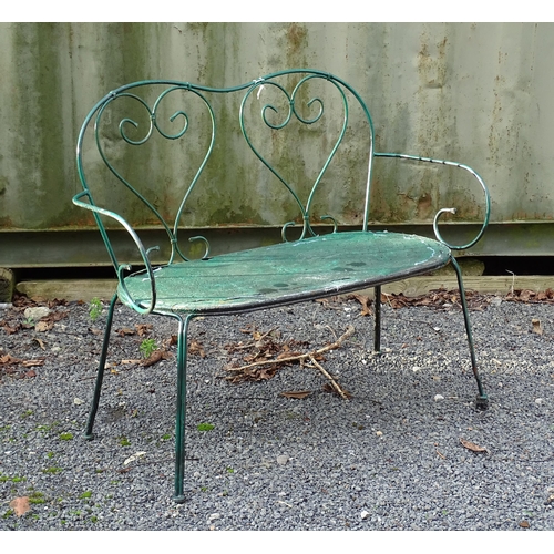 1364 - A two-seater garden bench, of wrought metal construction with two hearts forming the splat, green pa... 