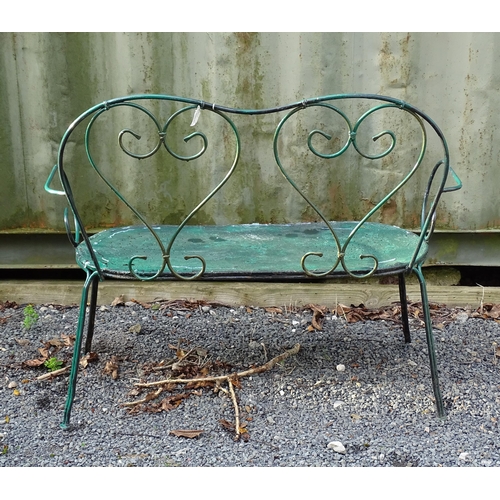 1364 - A two-seater garden bench, of wrought metal construction with two hearts forming the splat, green pa... 