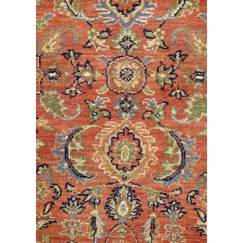 1387 - Carpet / Rug : A runner, the salmon ground with floral and foliate detail and decorative blue and cr... 