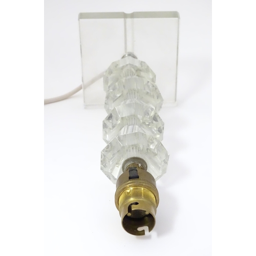 1340 - An Art Deco style table lamp, the glass column of stepped form with a squared base. Approx. 11 1/2