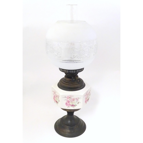 1348 - An early 20thC table oil lamp, the brass column with ceramic mid section decorated with roses and su... 