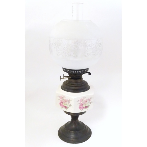 1348 - An early 20thC table oil lamp, the brass column with ceramic mid section decorated with roses and su... 