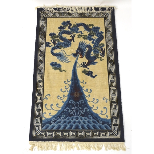 1393 - Carpets / Rugs : An Oriental rug depicting a stylised blue dragon above waves. Approx. 36