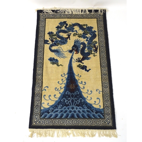 1393 - Carpets / Rugs : An Oriental rug depicting a stylised blue dragon above waves. Approx. 36