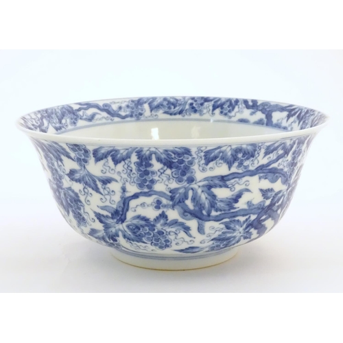 27 - A Chinese blue and white bowl decorated with vine leaves and grapes. Character marks under. Approx. ... 