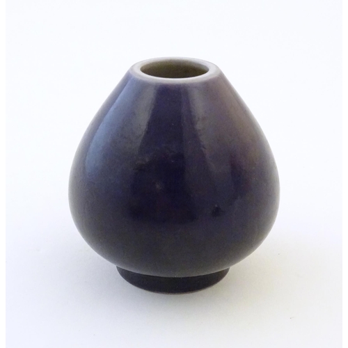 52 - A small Chinese pot of teardrop form with an indigo glaze. Character marks under. Approx. 2
