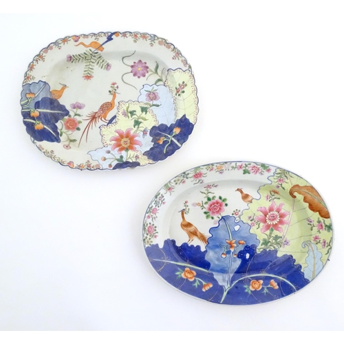 11 - Two Chinese export famille rose serving plates decorated in the tobacco leaf pattern with exotic phe... 