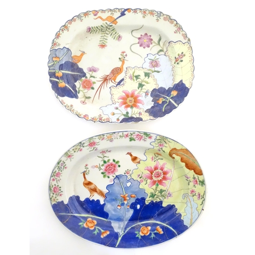 11 - Two Chinese export famille rose serving plates decorated in the tobacco leaf pattern with exotic phe... 