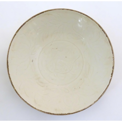23 - A Chinese Ding style plate with relief fish decoration. Approx. 8