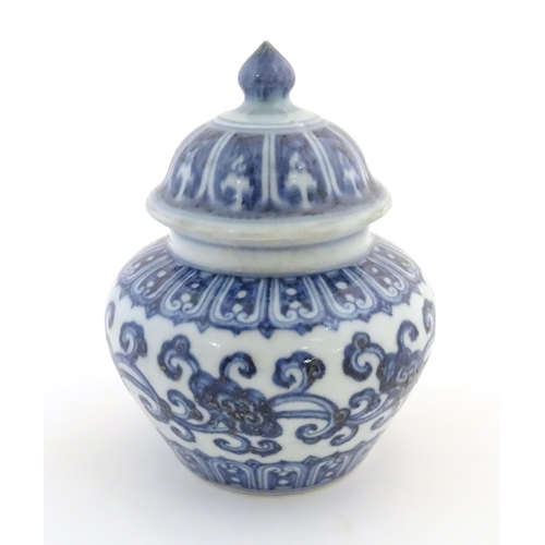 25 - A Chinese blue and white Ming style lidded ginger jar with an associated lid, decorated with stylise... 